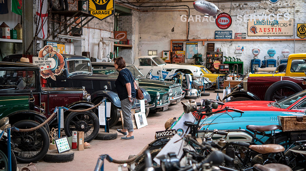 A view of classic cars and motorbikes lined up in the Llangollen Motor Museum